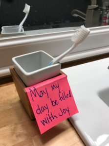 Health-and-Happiness-stickynote-reminder-on-toothbrush-holder